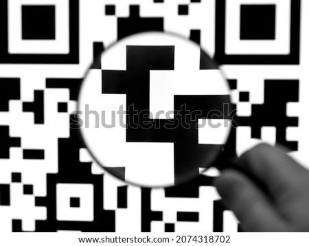 QR code is a type of matrix barcodes. Look through a magnifying glass. Code verification.