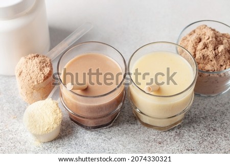 Various Protein sport shake and powder. Fitness food and drink. Royalty-Free Stock Photo #2074330321