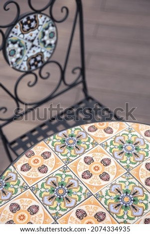 Textured table and chair with bright ornaments.
