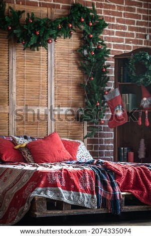 Christmas bedroom interior with red-green colors with a Christmas tree.