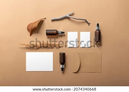 Cosmetics packaging branding mockup template with casual organic vibe, dropper, dispenser brown bottles, packaging and branding items. Blank isolated on beige background to place your design. 