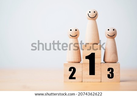 Wooden human standing on podium with ranking for winner business and sport competition concept. Royalty-Free Stock Photo #2074362622