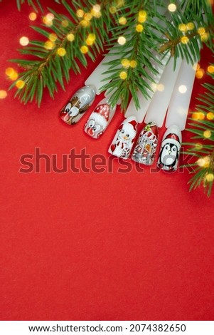 Christmas nail picture  Santa snowman ,penguin  ,reindeer  .Christmas flat lay frame with copy space on red bachground Vertical . beauty salon concept .