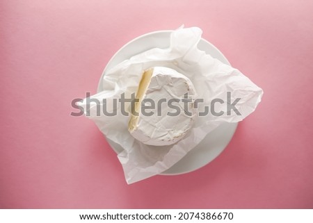 Appetizing delicacies. Piece of cheese on pink background