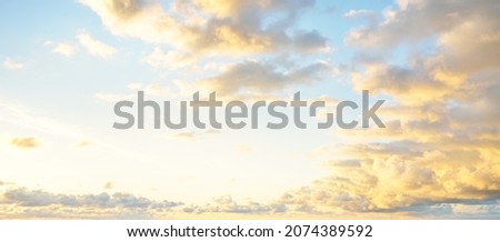 Clear blue sky, pink and golden cirrus and cumulus clouds after storm at sunset. Dramatic cloudscape. Concept art, meteorology, heaven, hope, peace, graphic resources, picturesque panoramic scenery Royalty-Free Stock Photo #2074389592