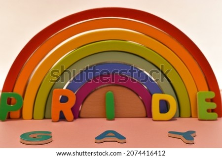 Vaduz, Liechtenstein, October 17, 2021 Colorful rainbow with the words pride and gay on a pink background