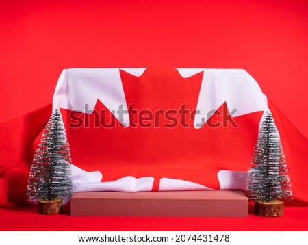 Christmas winter podium festive scene mockup on red background with canadian flag. Holiday advertisement, greeting card template