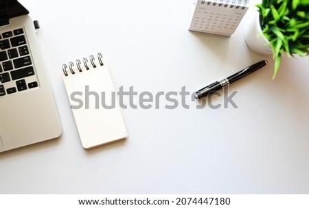 Blank notebook on desk and laptop copy space,Top view, flat lay