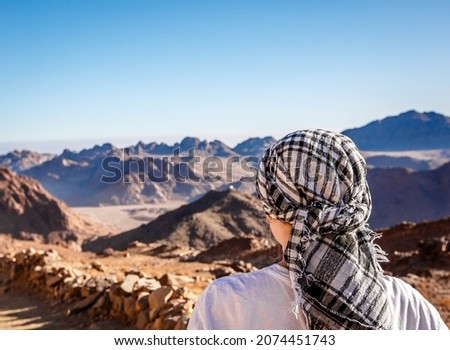 Muslim man in traditional Keffiyeh on top of Mount Moussa in South Sinai, Egypt Royalty-Free Stock Photo #2074451743