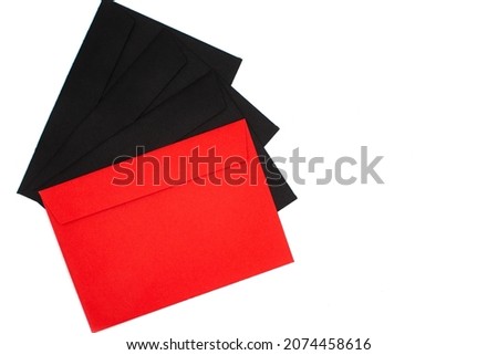 Photos of a red envelope on a background of black envelopes