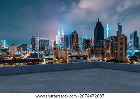 Panoramic Kuala Lumpur skyline view, concrete observatory deck on rooftop, night. Asian corporate and residential lifestyle. Financial city downtown, real estate. Product display mockup empty roof Royalty-Free Stock Photo #2074472887