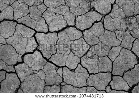 Dry cracked earth, parched land, Earth dirt texture background of brown mud, arid soil, Dry cracked earth texture, cracked earth, Dry mud, broken texture, desert, Global Warming, Climate Change. Royalty-Free Stock Photo #2074481713