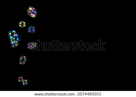 Soap bubbles isolated on a black background. Copy space. 