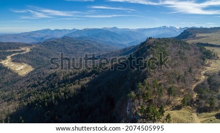 Autumn landscape of Adygea - panorama of the LagoNaki plateau from a bird's eye view in red tones