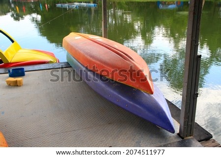 Colourful Canoes on a Wooden Floating Pontoon in a Harbour