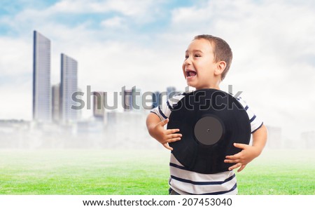 portrait of a little boy holding a vinyl record
