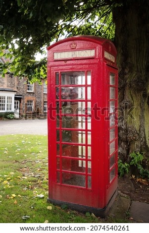 old red english telephone box in the village of  Castle Acre 