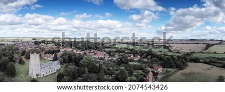 panoramic landscape image with Church of Saint James the Great in Castle Acre england
