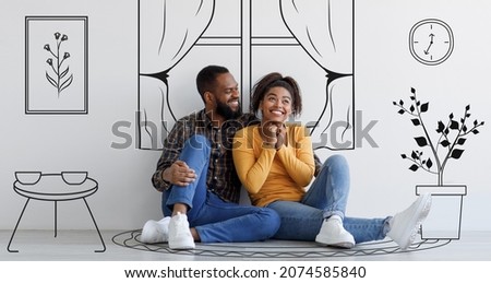 Black guy and his excited girlfriend imagining their new furnished home sitting on floor against white wall background with interior drawings doodle, day dreaming about new house renovation, banner Royalty-Free Stock Photo #2074585840