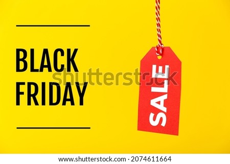 Black Friday Sale red price tag isolated on yellow background. Shopping, sale, discount concept