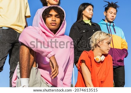 Multicultural group of young friends bonding outdoors and having fun - Stylish cool teens gathering at urban skate park Royalty-Free Stock Photo #2074613515
