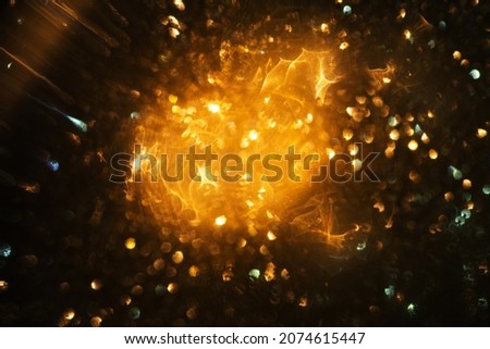 Abstract and festive background with golden yellow lights. De focused blurred lights.