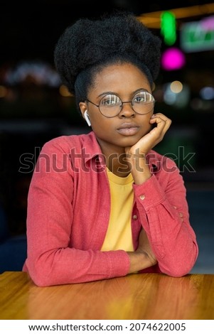A millennial African American woman works or a student talks via video communication from a laptop or smartphone with friends or colleagues. working on a project or diploma online education or work on