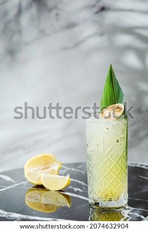 citrus cocktail or lemonade on marble table. concept of alcoholic or non-alcoholic drink.