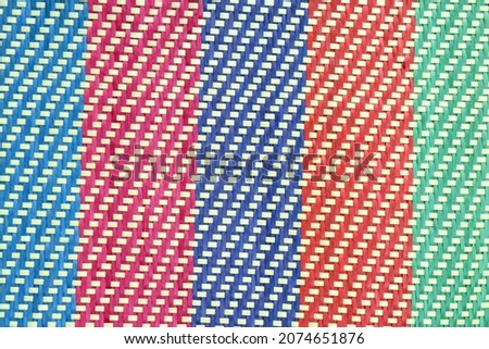 The colorful background in the form of stripes is woven