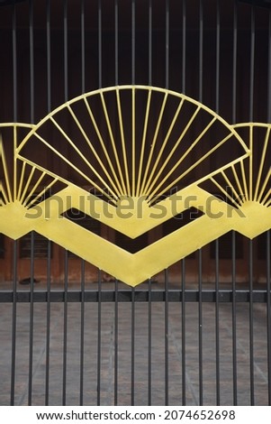 House fence ornament with a fan in yellow color
