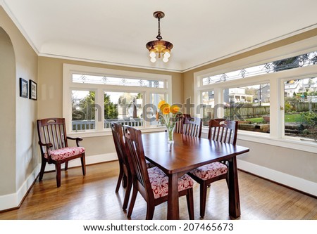 Bright dining room with hardwood floor and table set