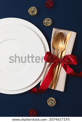 Festive christmas, wedding, birthday table setting with golden cutlery and porcelain plate. Mockup for place card, restaurant menu template. Copy space