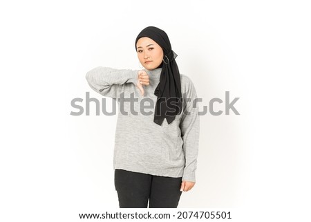 Showing Thumbs Down of Beautiful Asian Woman Wearing Hijab Isolated On White Background