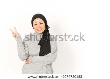Showing Peace Sign of Beautiful Asian Woman Wearing Hijab Isolated On White Background