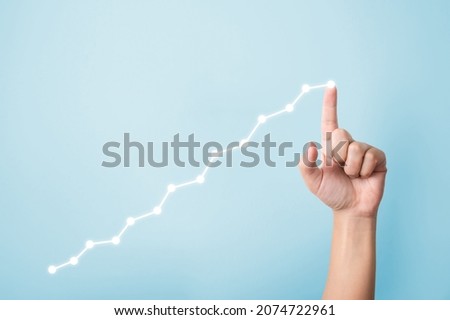 Growth business concept. Hand pointing increase graph moving up and copy space