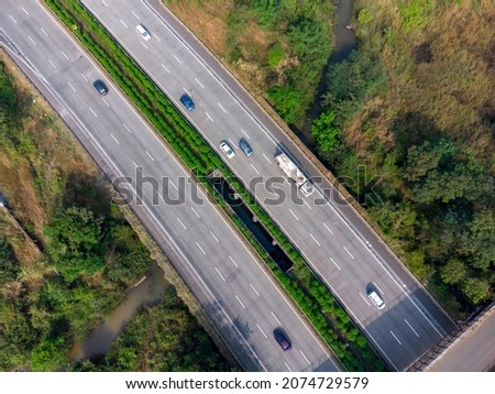 Aerial footage of the Mumbai-Pune Expressway near Pune India. The Expressway is officially called the Yashvantrao Chavan Expressway. Royalty-Free Stock Photo #2074729579