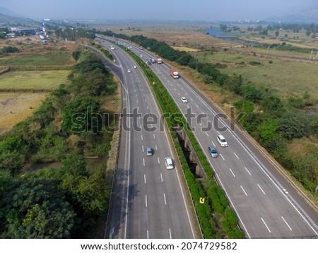 Aerial footage of the Mumbai-Pune Expressway near Pune India. The Expressway is officially called the Yashvantrao Chavan Expressway. Royalty-Free Stock Photo #2074729582