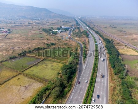 Aerial footage of the Mumbai-Pune Expressway near Pune India. The Expressway is officially called the Yashvantrao Chavan Expressway. Royalty-Free Stock Photo #2074729588