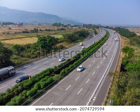 Aerial footage of the Mumbai-Pune Expressway near Pune India. The Expressway is officially called the Yashvantrao Chavan Expressway. Royalty-Free Stock Photo #2074729594