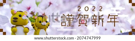 Japanese New Year's in 2022. vector banner. Doll self-made in clay. In Japanese it is written "Happy new year".