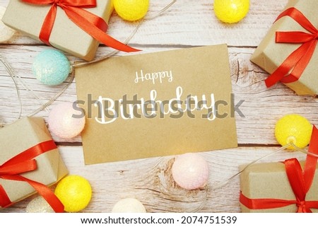 Happy Birthday card typography text with LED cotton ball on wooden background