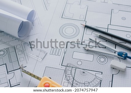 Architect workplace top view. blueprints, blueprint rolls and divider compass, calipers on table. Construction background. Engineering tools. Copy space
