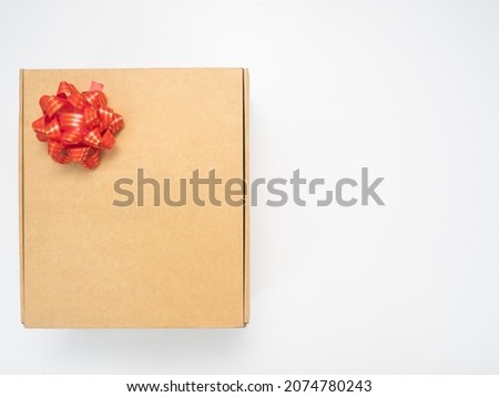 Gift box red ribbon on white table top view copy space