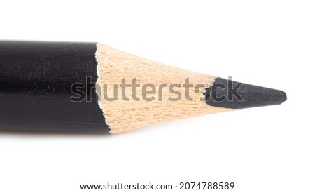 Black pencil isolated on a white background. Macro