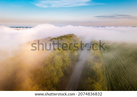 Breathtaking top view of the road passing through the agricultural lands. Location place Dniester river, Ukraine, Europe. Aerial photography, drone shot. Photo wallpaper. Discover the beauty of earth.