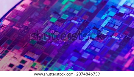 Macro of silicon wafer semiconductor with neon color - integrated circuits to manufacture CPU and GPU