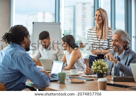 Shot of a group of businesspeople having a meeting in a modern office. Shot of a group of businesspeople sitting together in a meeting. Team of professionals discussing over new business project