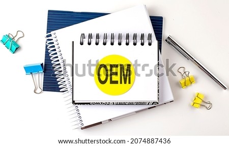 Sticker with OEM text on notebooks on white background