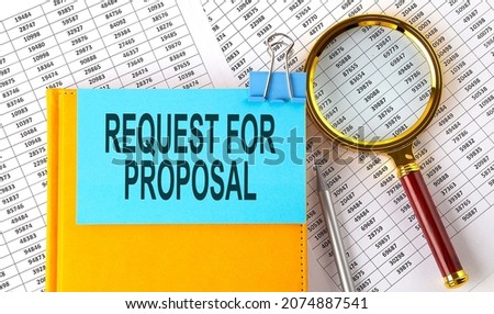 REQUEST FOR PROPOSAL text on sticker on notebook with magnifier and chart. Business