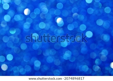 Abstract background of cold winter blue bokeh defocused blurred lights and glitter sparkles Royalty-Free Stock Photo #2074896817